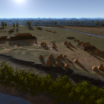 Aerial view of a reconstructed ancient village with clusters of small huts and larger structures, surrounded by trees, water, and open grassland under a bright sky.